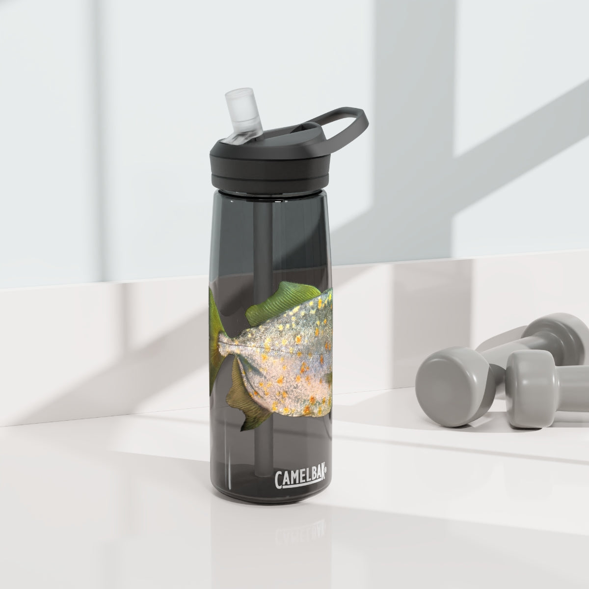 Silver and Spec Fish CamelBak Eddy® Water Bottle in 20oz and 25oz sizes, showcasing its durable Tritan™ material and spill-proof design.