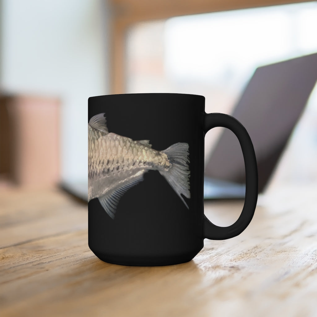 A stylish 15oz black ceramic mug with rounded corners and a C-handle, featuring a unique silver fish design.