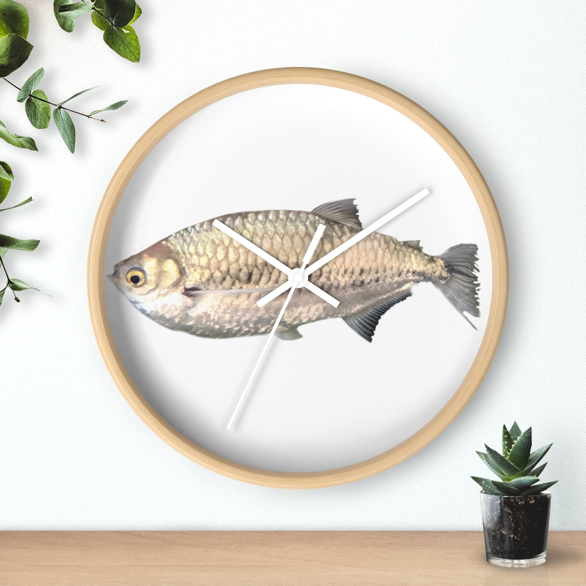 A stylish Silver Fish Wall Clock with a wooden frame and plexiglass face, featuring a unique fish design, perfect for indoor decor.