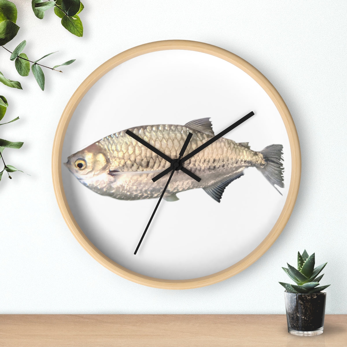 A stylish Silver Fish Wall Clock with a wooden frame and plexiglass face, featuring a unique fish design, perfect for indoor decor.