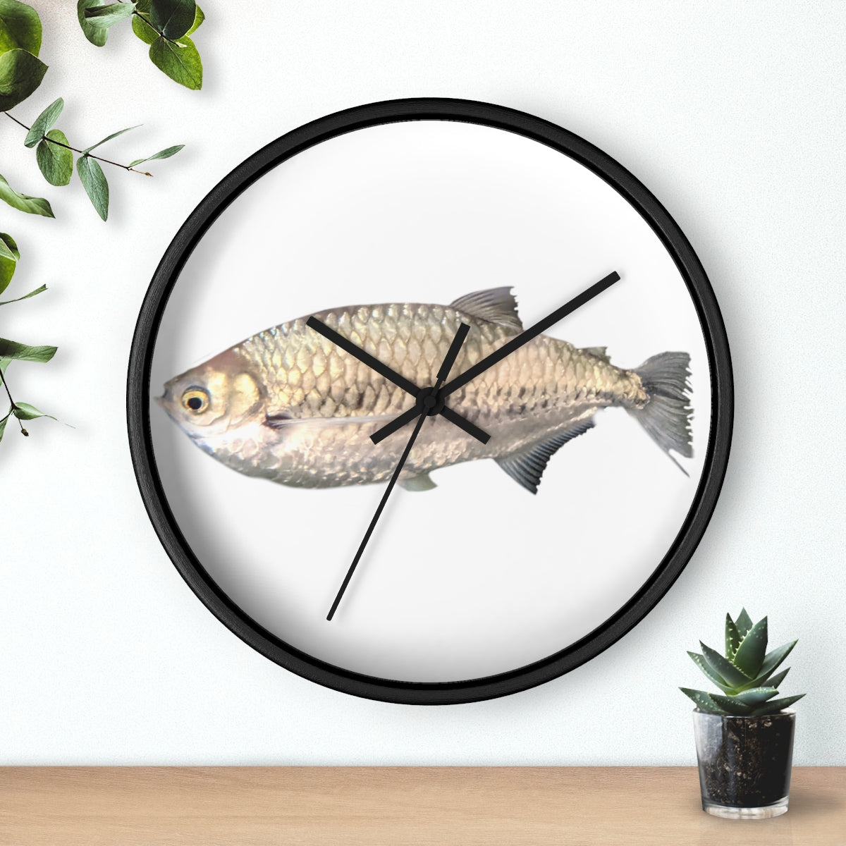 A stylish Silver Fish Wall Clock with a wooden frame and plexiglass face, featuring a unique fish design, perfect for indoor decor.