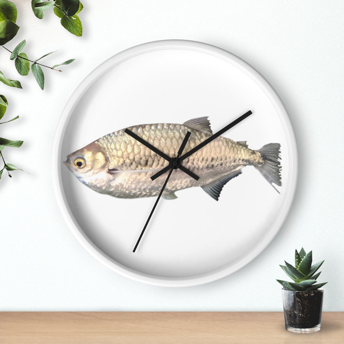 A stylish Silver Fish Wall Clock with a wooden frame and plexiglass face, featuring a unique fish design, perfect for indoor decor.