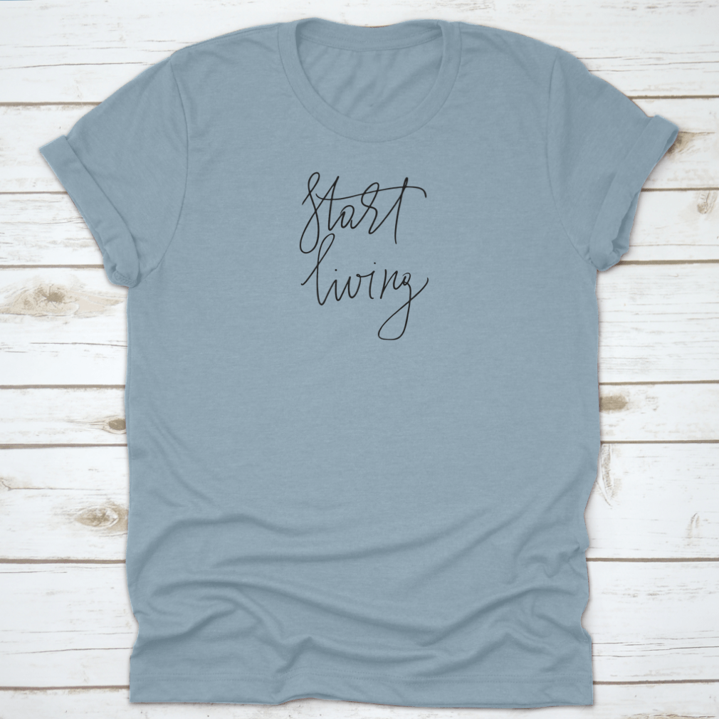 A stylish t-shirt featuring the cursive text 'Start Living' printed on the front, made from soft cotton fabric.