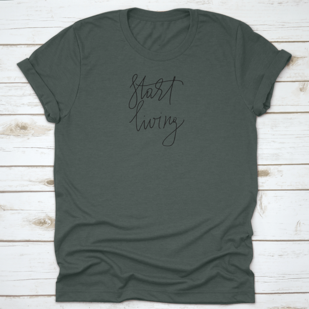 A stylish t-shirt featuring the cursive text 'Start Living' printed on the front, made from soft cotton fabric.