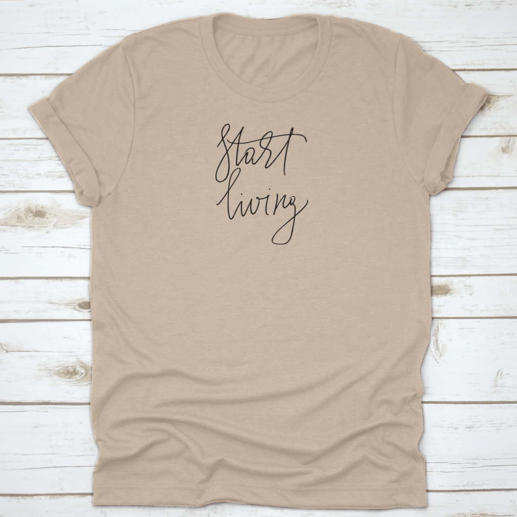 A stylish t-shirt featuring the cursive text 'Start Living' printed on the front, made from soft cotton fabric.