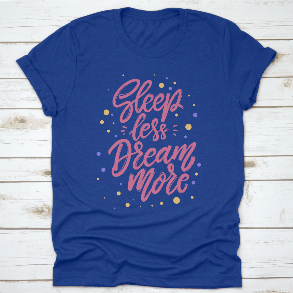 A stylish T-shirt featuring the phrase 'Sleep Less Dream More' in a cute lettering design, made from 100% cotton for comfort.