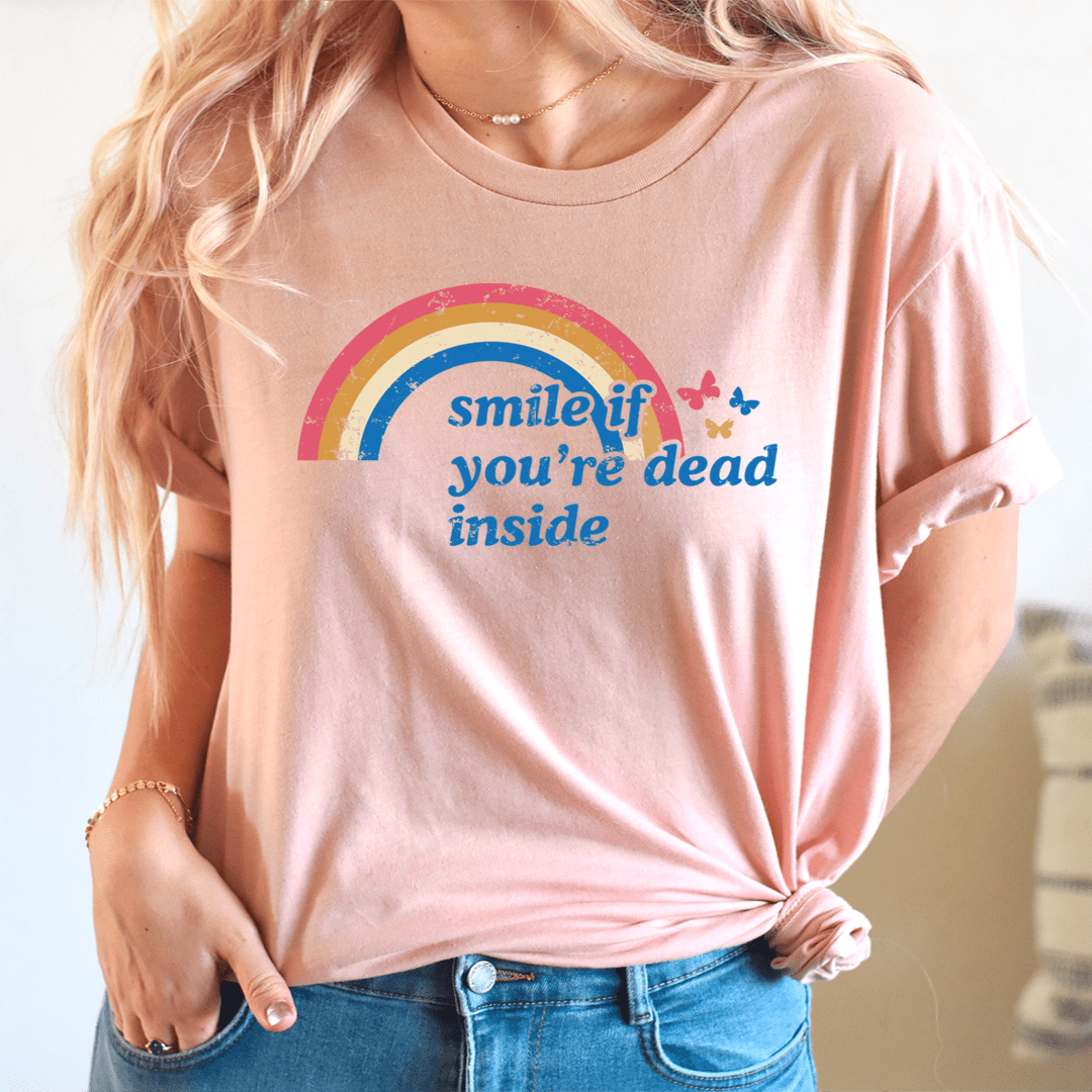 A black t-shirt featuring the phrase 'Smile If You're Dead Inside' printed in bold white letters, showcasing its soft fabric and durable stitching.