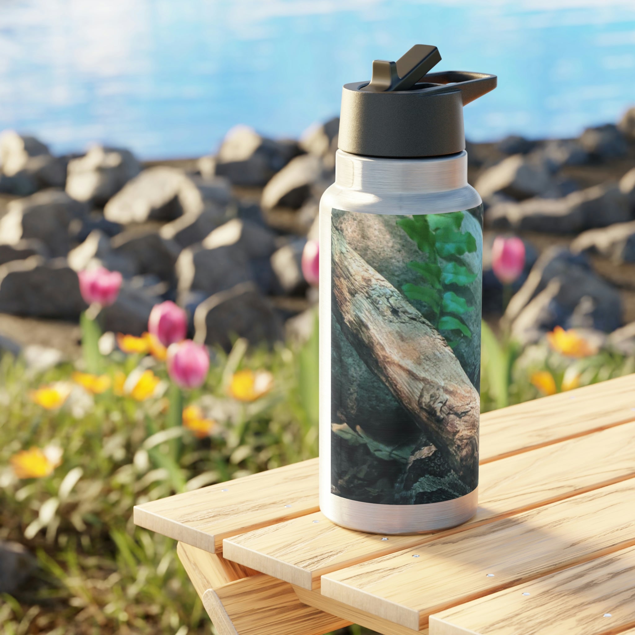 A stylish Snake Gator Tumbler in stainless steel with a black screw-on cap and a plastic straw, showcasing a customizable design.