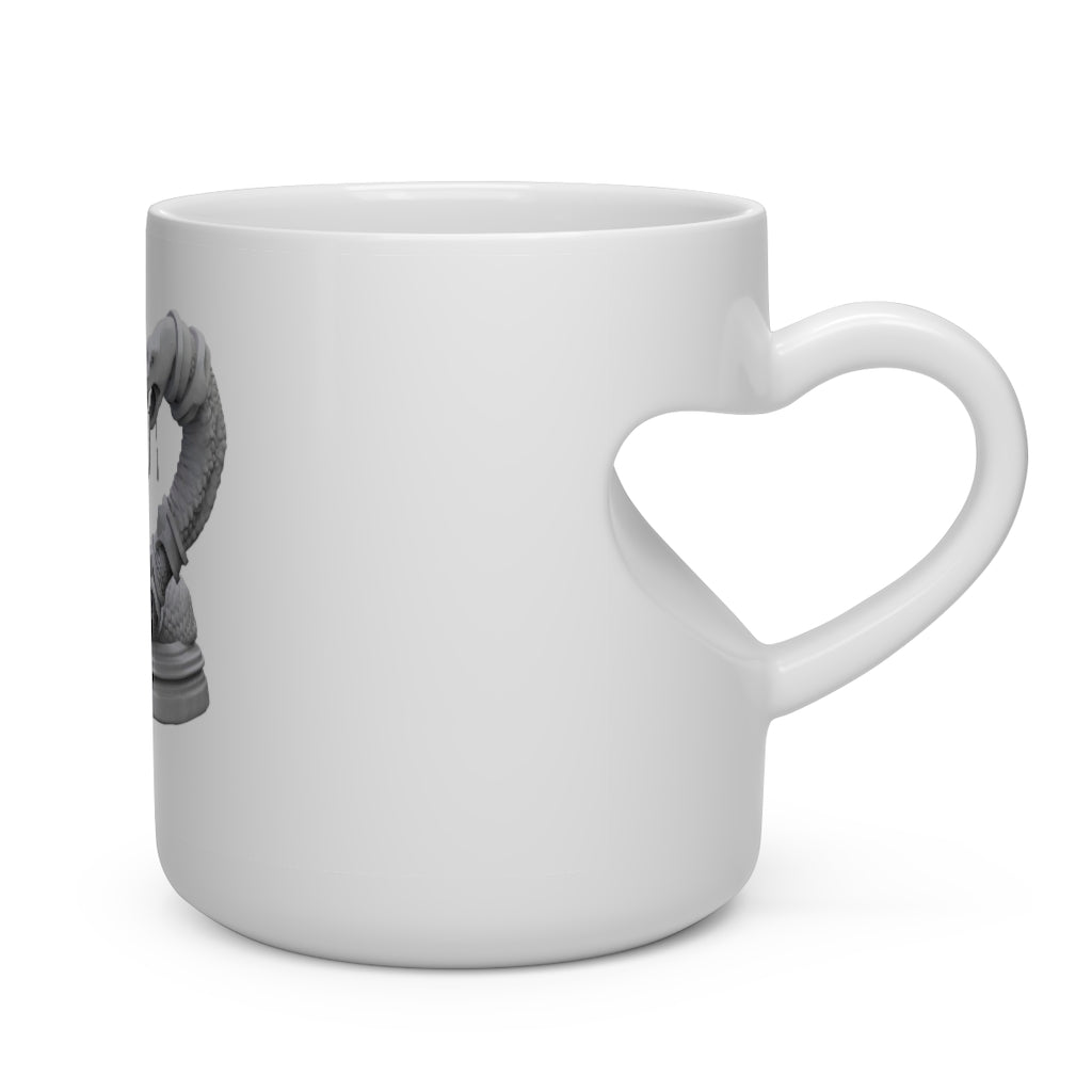 A white ceramic mug shaped like a heart with a snake design on the handle, perfect for hot beverages.