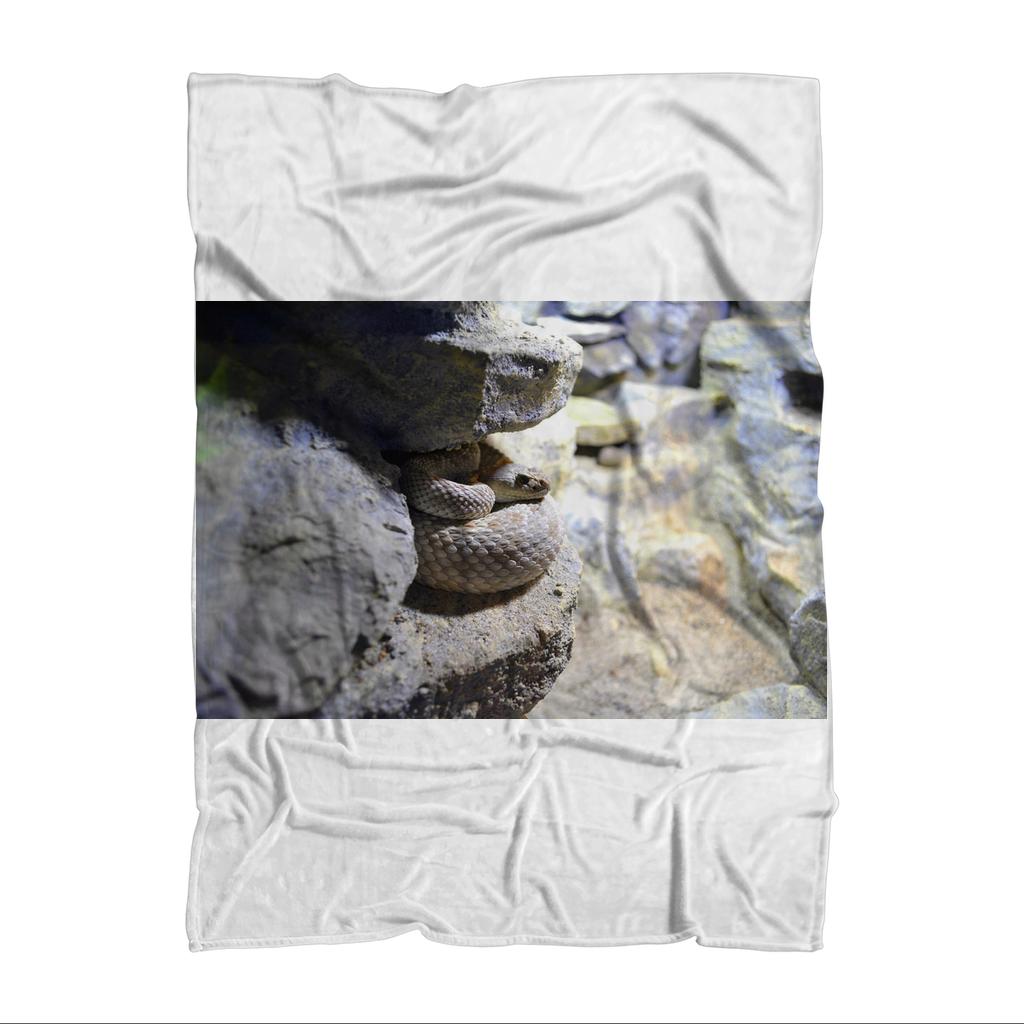 A cozy Snake Sublimation Throw Blanket featuring vibrant snake patterns on soft polar fleece fabric, perfect for home decor.