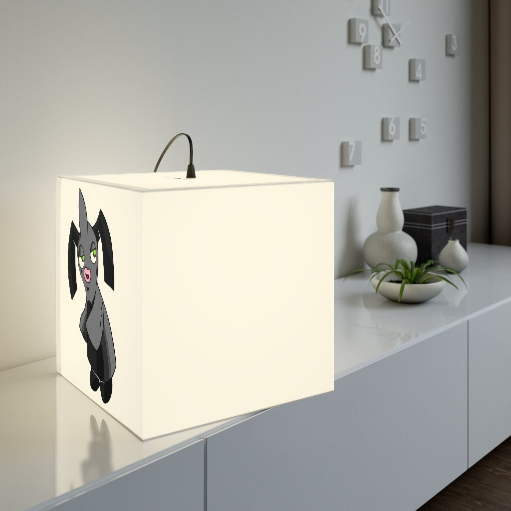 A stylish Snaughtnaut Personalized Lamp in a cube shape, showcasing unique designs and available in two sizes, perfect for indoor lighting.