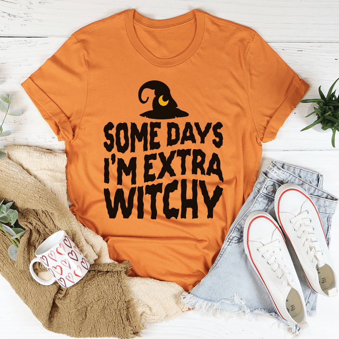 A stylish black t-shirt with the phrase 'Some Days I'm Extra Witchy' printed in a whimsical font, showcasing its soft fabric and durable stitching.