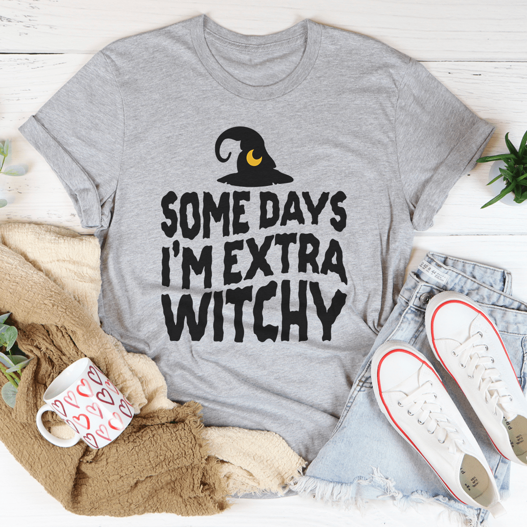 A stylish black t-shirt with the phrase 'Some Days I'm Extra Witchy' printed in a whimsical font, showcasing its soft fabric and durable stitching.