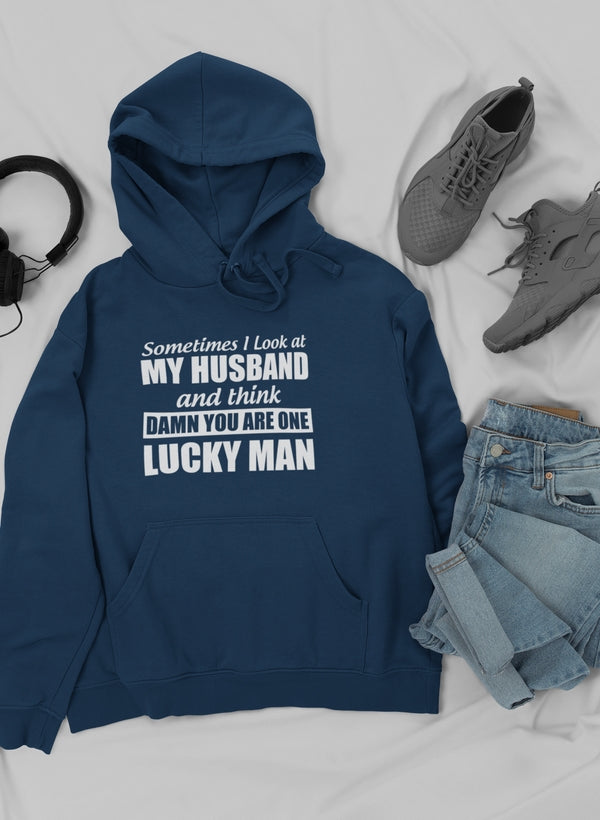 A cozy hoodie featuring the quote 'Sometimes I Look At My Husband and Think Damn You Are One Lucky Man', designed by top artists.