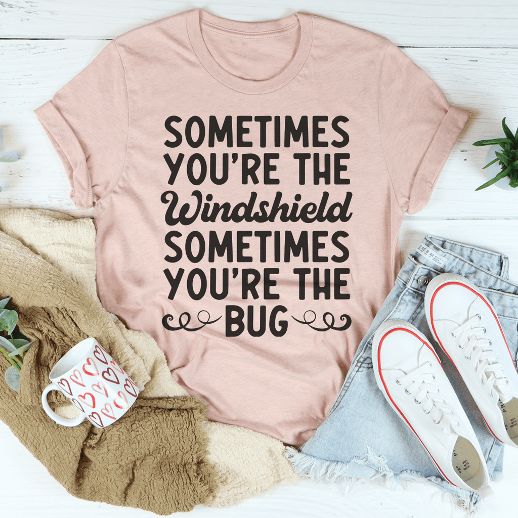 A humorous t-shirt featuring the phrase 'Sometimes You're The Windshield Sometimes You're The Bug', made from soft cotton with double stitching.