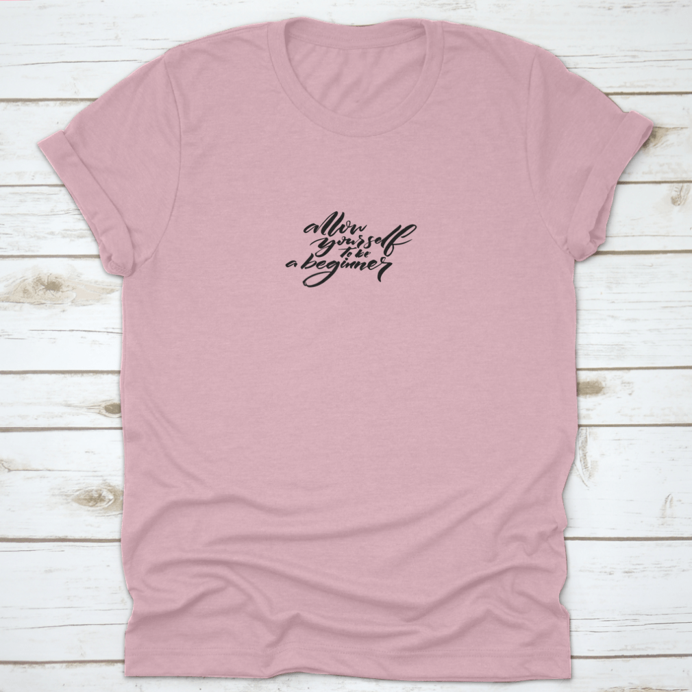 A comfortable cotton t-shirt featuring the motivational quote 'Allow Yourself To Be A Beginner' in a stylish font, perfect for inspiring beginners.