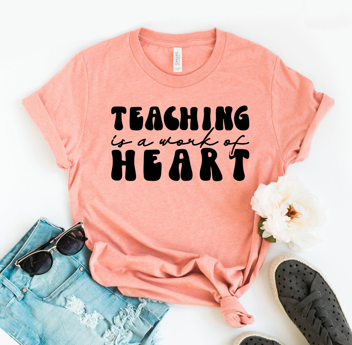 A comfortable 'Teaching Is A Work Of Heart' T-shirt made from premium ring spun cotton, featuring a vibrant flex print design.