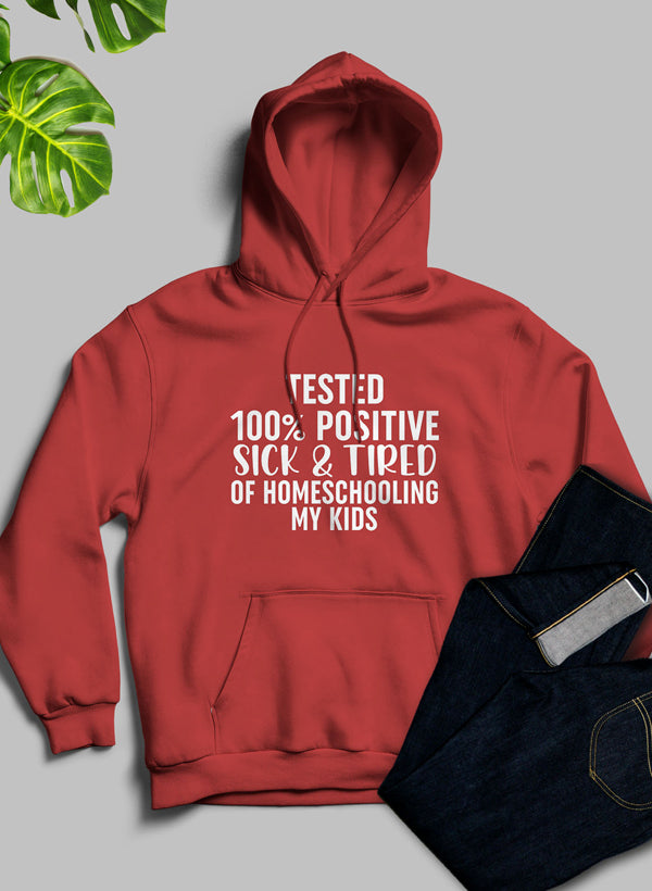 Cozy hoodie with a humorous design saying 'Sick & Tired Of Homeschooling My Kids', featuring an adjustable hood and banded cuffs.