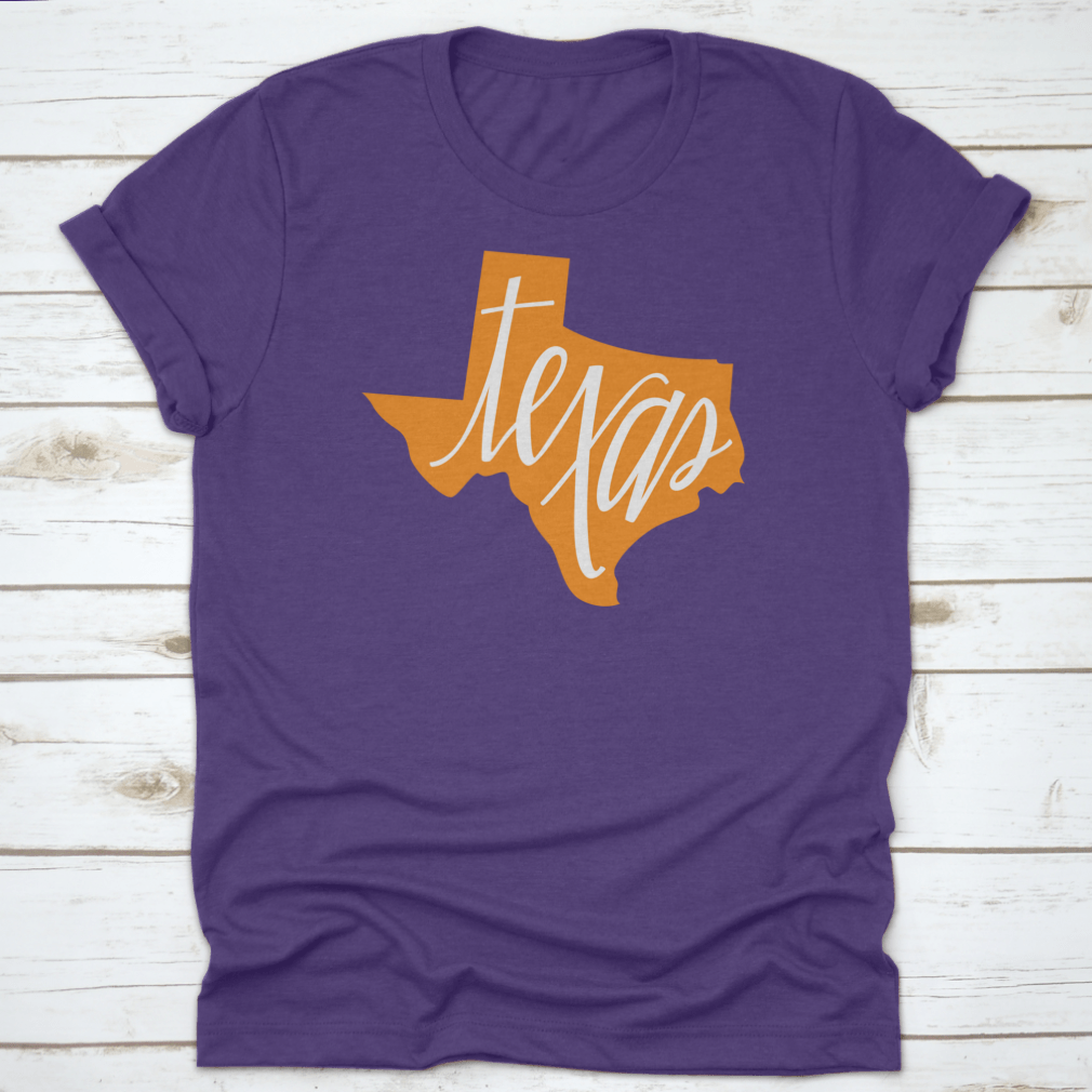 A stylish Texas State Outline and Hand Lettering Shirt, showcasing a unique design on a comfortable cotton fabric.