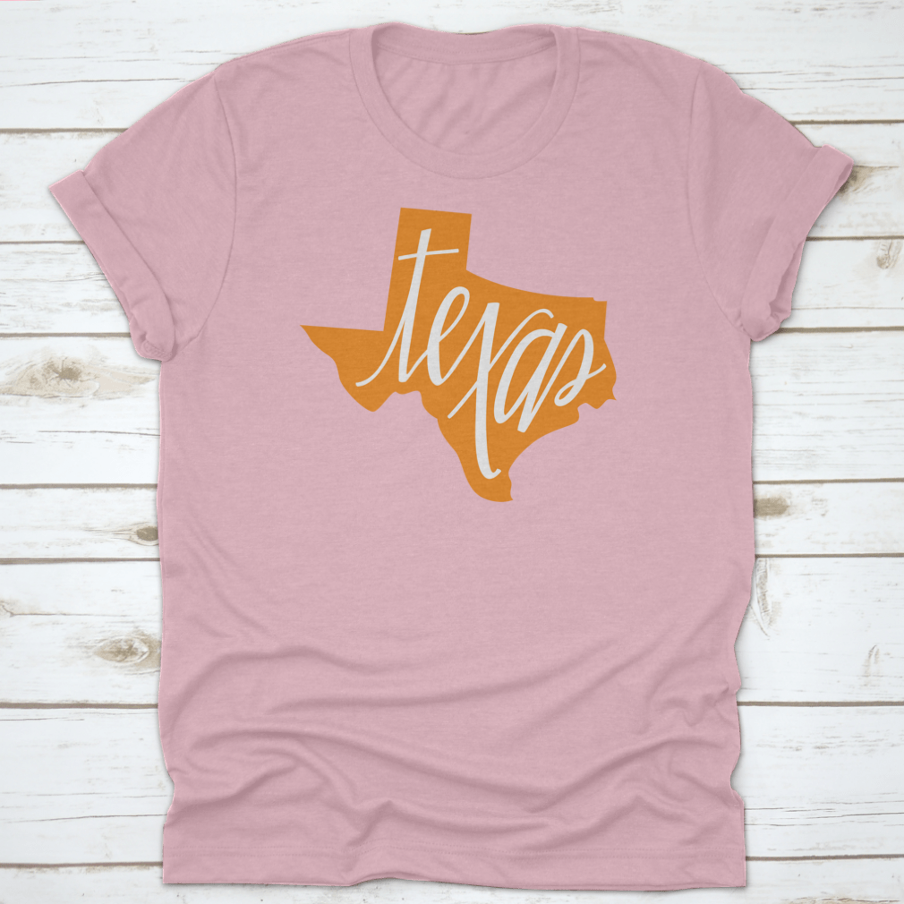 A stylish Texas State Outline and Hand Lettering Shirt, showcasing a unique design on a comfortable cotton fabric.