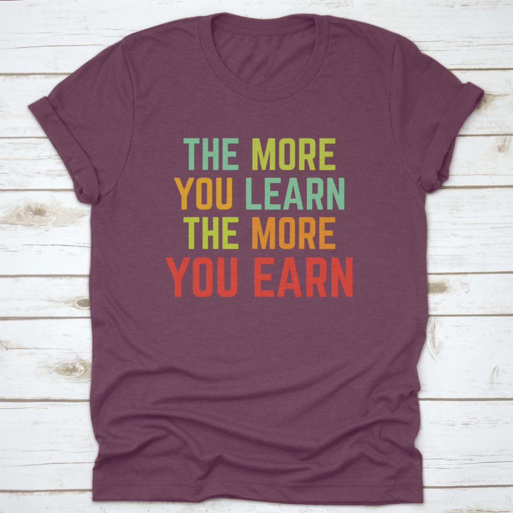 A comfortable and stylish t-shirt featuring the phrase 'The More You Learn', made from 100% cotton with a classic fit.