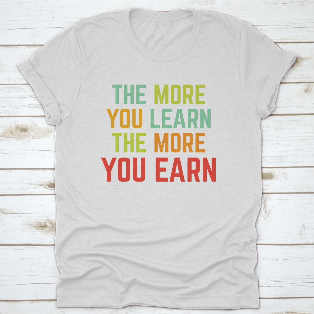 A comfortable and stylish t-shirt featuring the phrase 'The More You Learn', made from 100% cotton with a classic fit.