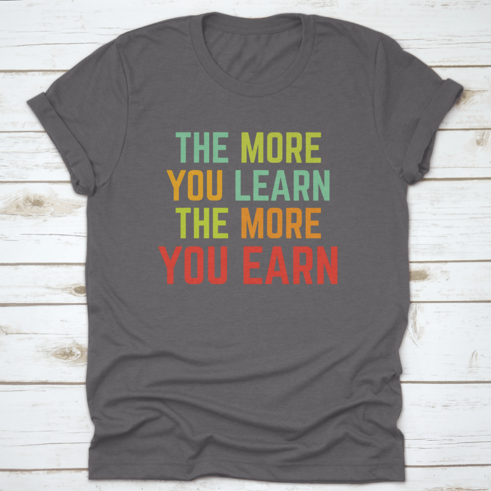 A comfortable and stylish t-shirt featuring the phrase 'The More You Learn', made from 100% cotton with a classic fit.