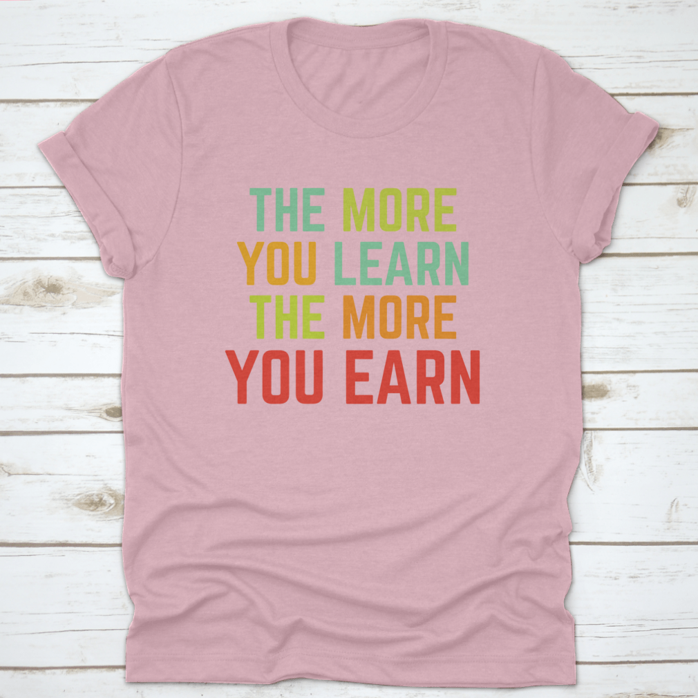 A comfortable and stylish t-shirt featuring the phrase 'The More You Learn', made from 100% cotton with a classic fit.