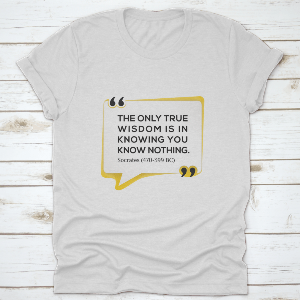 Inspirational T-shirt featuring the quote 'The Only True Wisdom Is In Knowing You Know Nothing', made from 100% cotton, displayed on a neutral background.