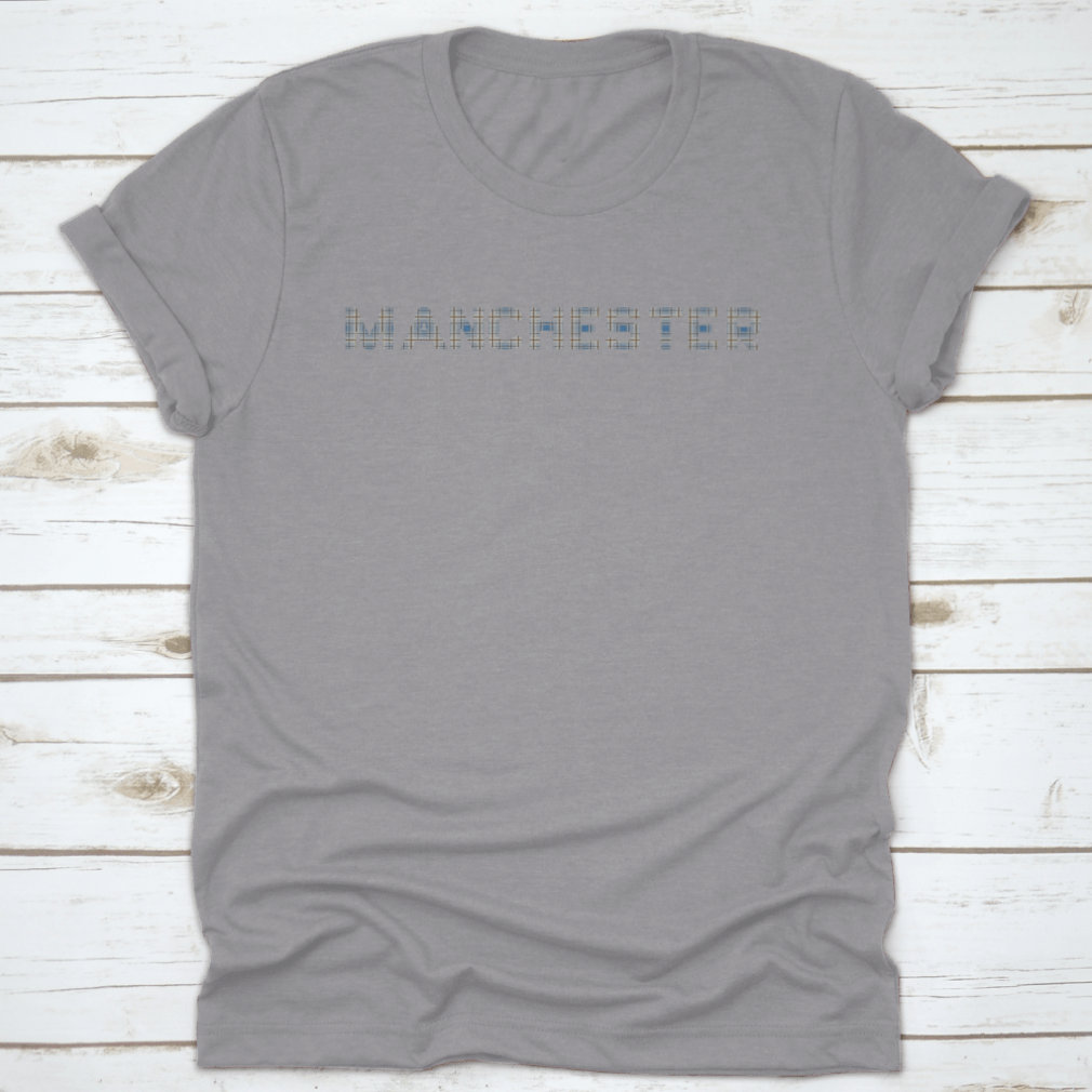 A stylish t-shirt featuring the word 'Manchester' designed with letters from the Manchester Tartan pattern, showcasing vibrant colors and a classic fit.