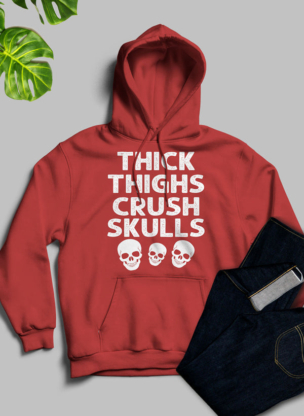 Thick Thighs Crush Skulls Hoodie featuring a unique artistic design, cozy fleece material, and adjustable hood.