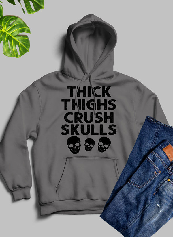 Thick Thighs Crush Skulls Hoodie featuring a unique artistic design, cozy fleece material, and adjustable hood.