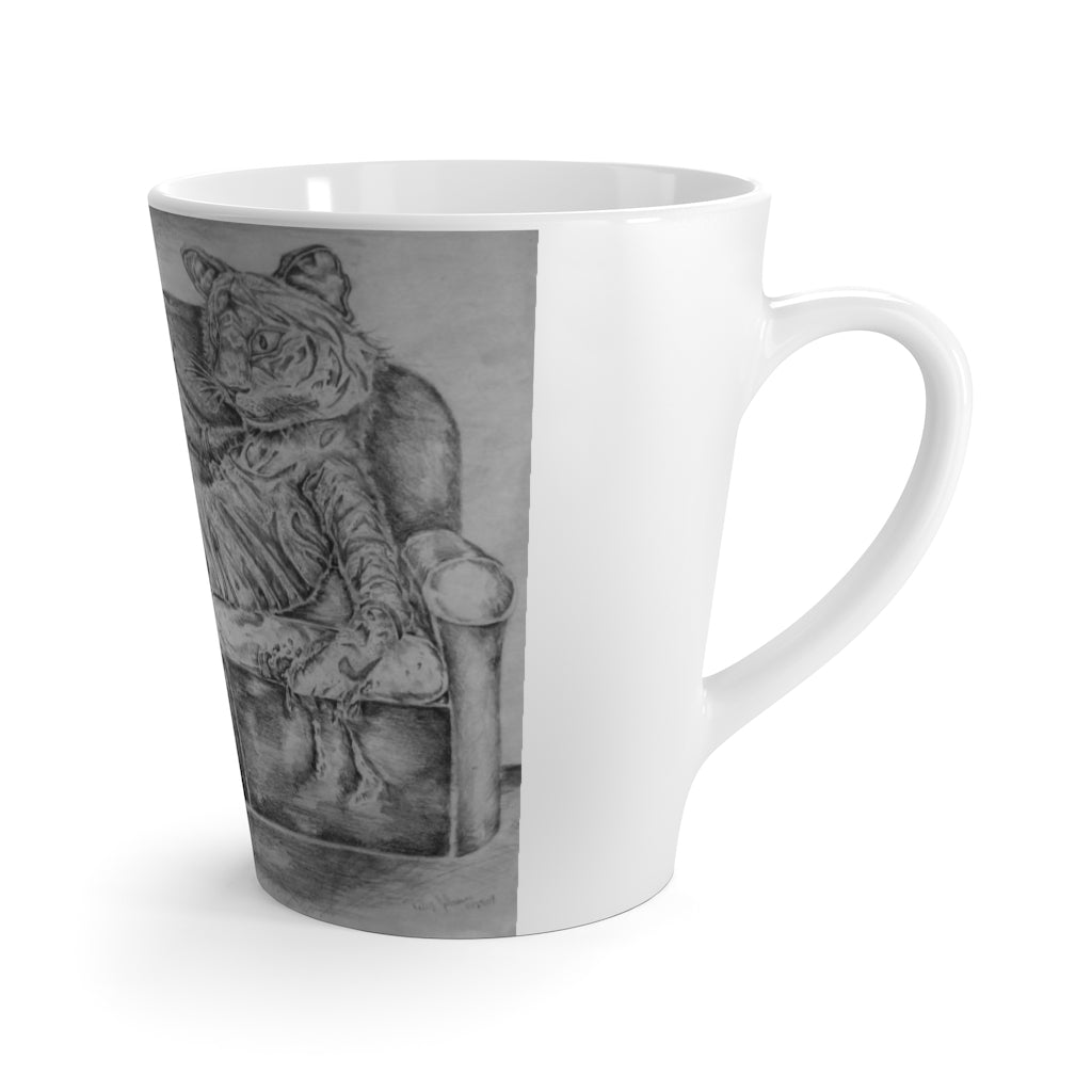 A white ceramic latte mug featuring a playful tiger design lounging on a couch, perfect for coffee lovers.