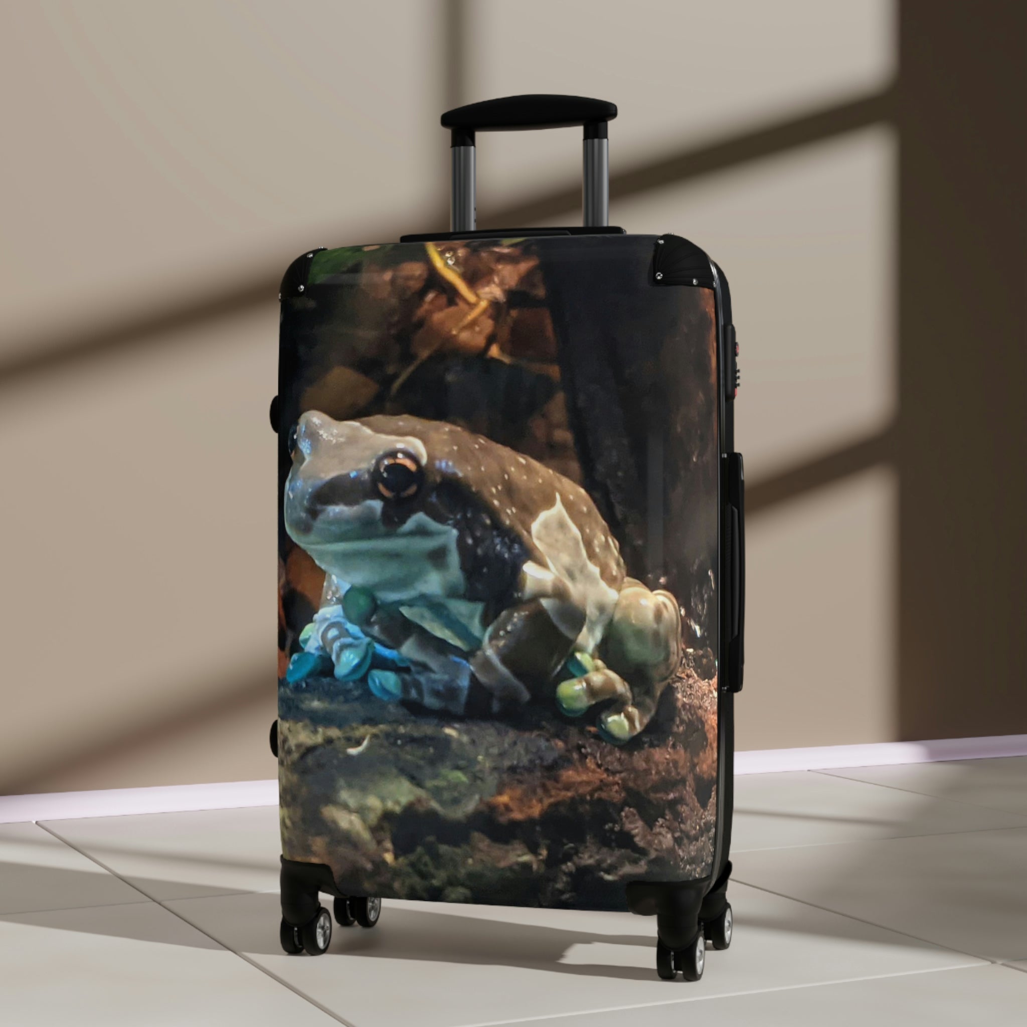 Toad Cabin Suitcase featuring a personalized design, lightweight polycarbonate front, and ABS back, with adjustable handle and 360° swivel wheels.