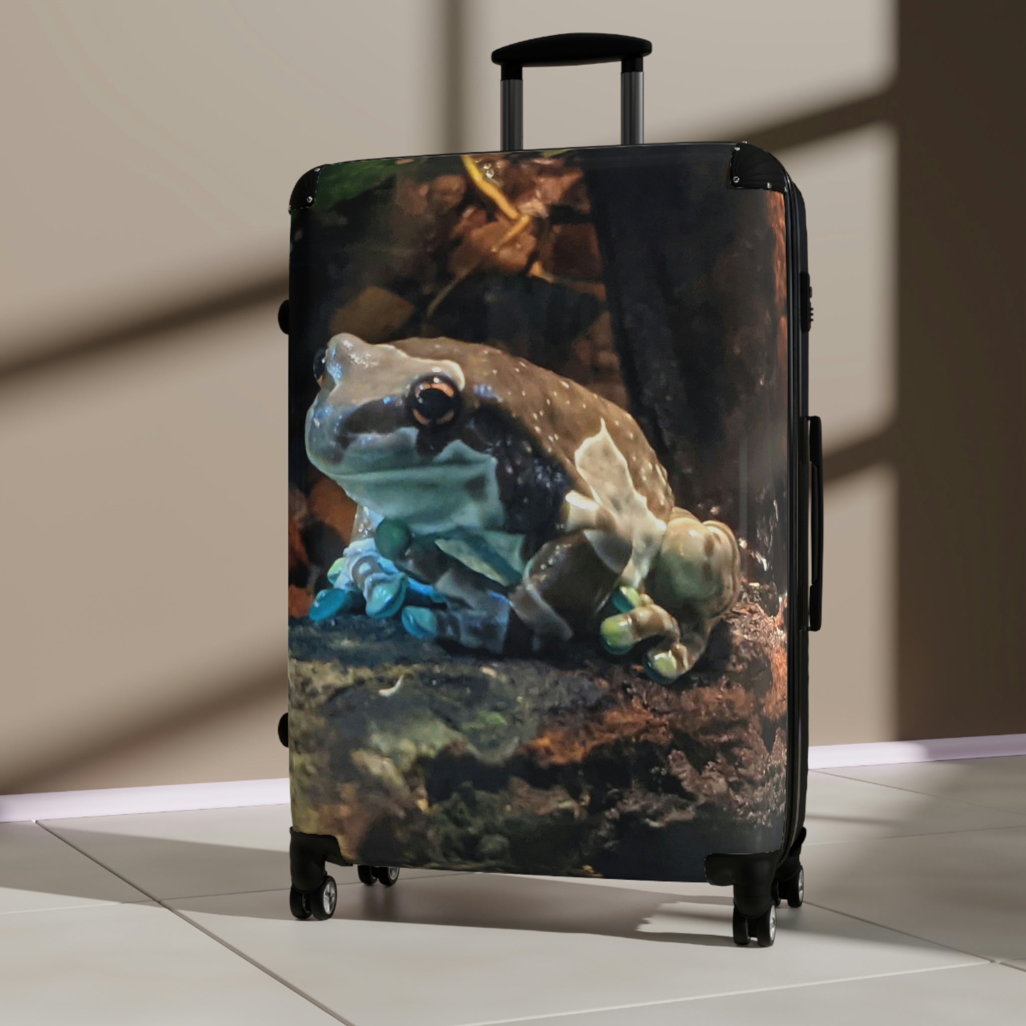 Toad Cabin Suitcase featuring a personalized design, lightweight polycarbonate front, and ABS back, with adjustable handle and 360° swivel wheels.