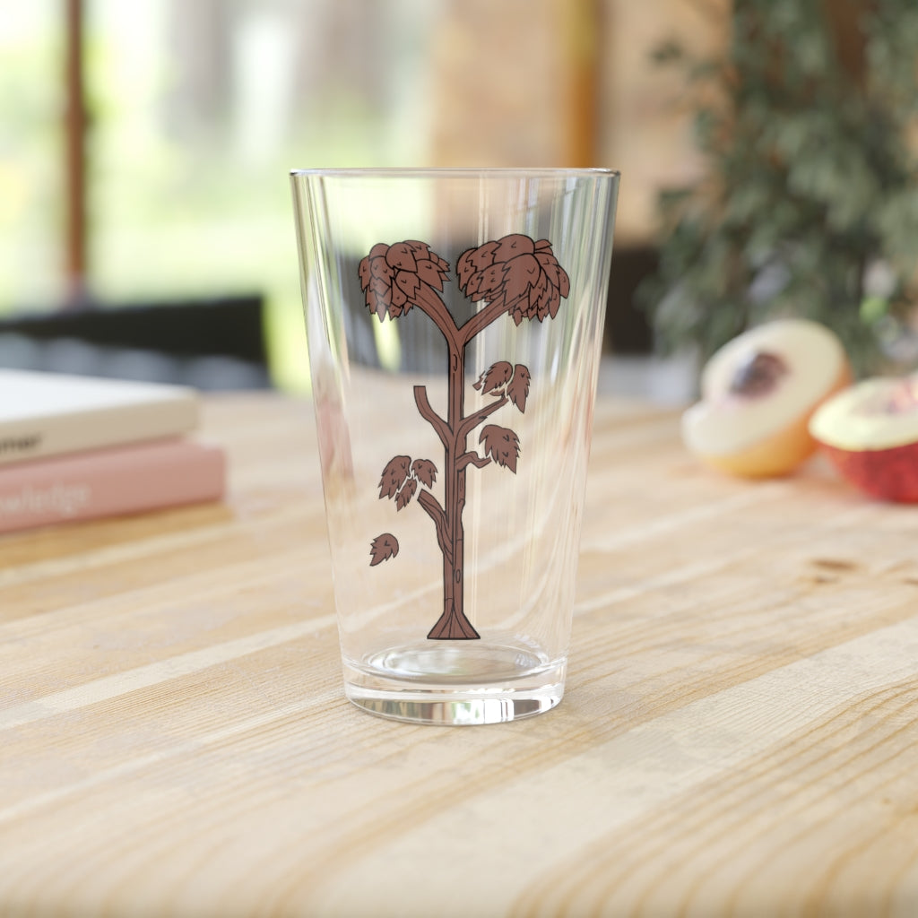 A clear 16oz Tree Pint Glass showcasing a customizable design, perfect for beverages.