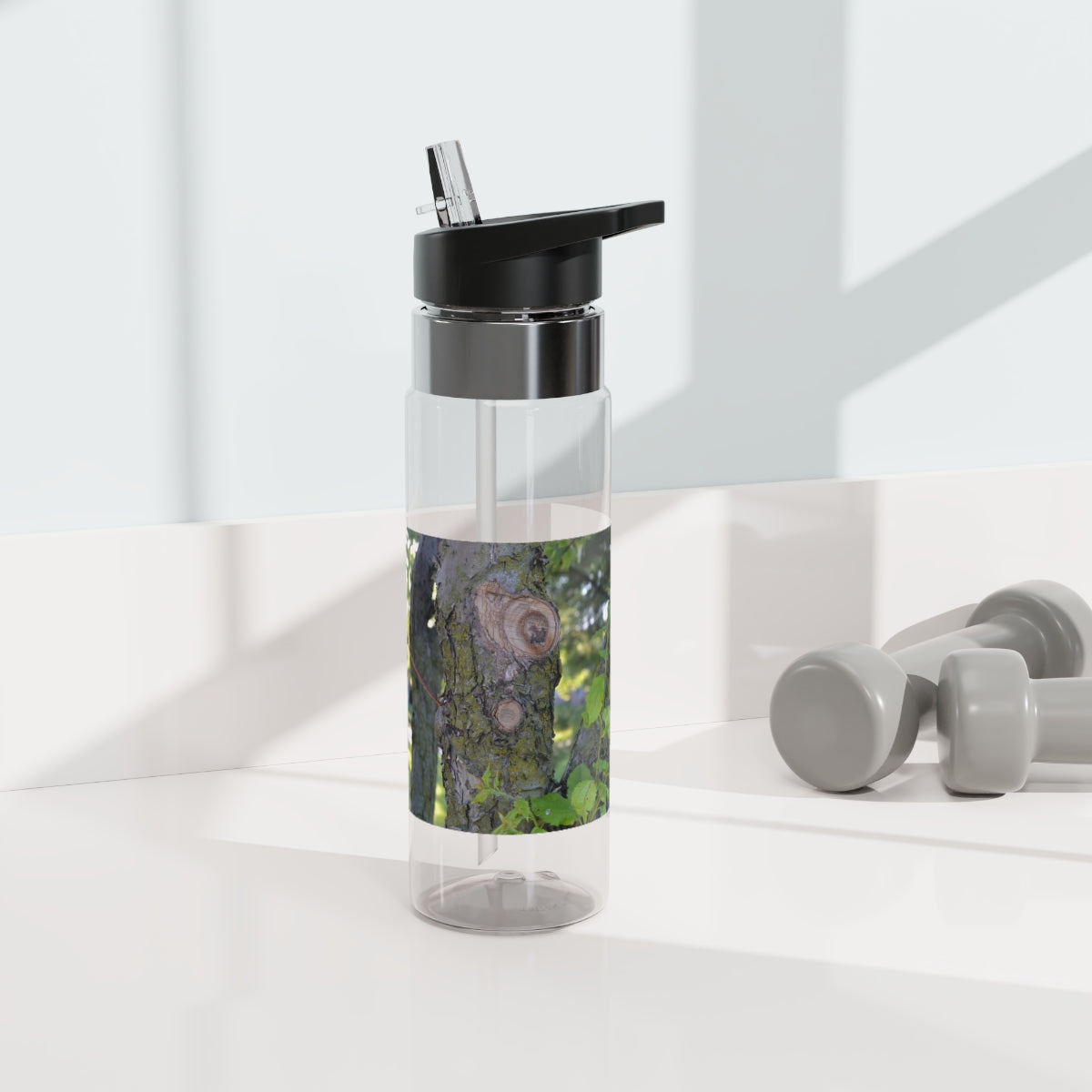 Tree Stump and Green Leaves Kensington Tritan™ Sport Bottle, 20oz, featuring a stylish design and a convenient carabiner hook.