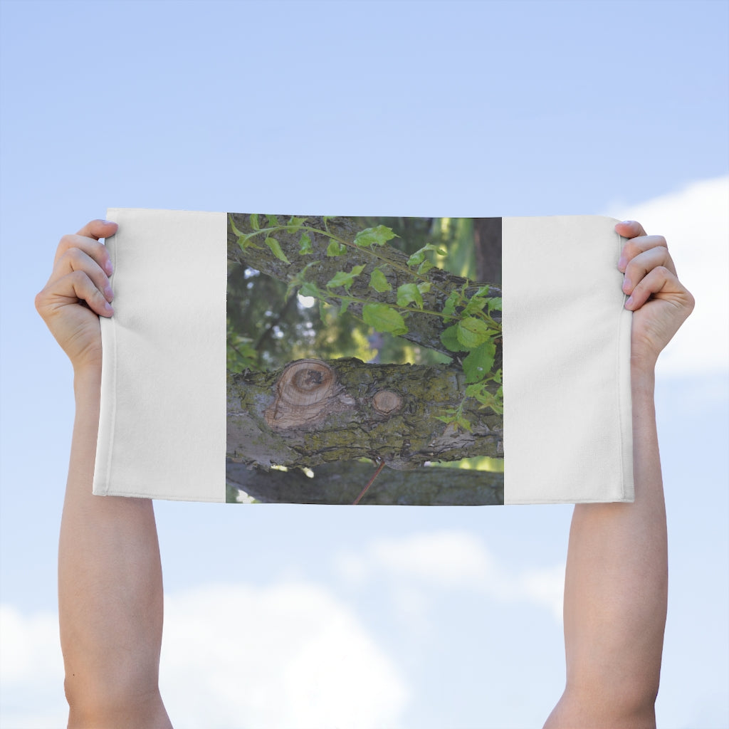 Tree Stump and Green Leaves Rally Towel, featuring a soft polyester front and absorbent cotton backing, measuring 11x18 inches.