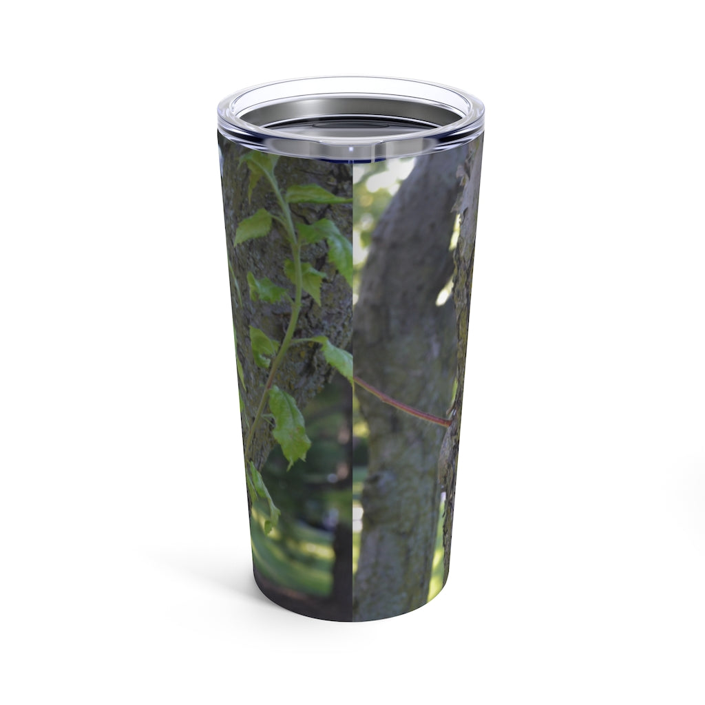 20oz stainless steel tumbler featuring a tree stump and green leaves design, perfect for travel and outdoor use.