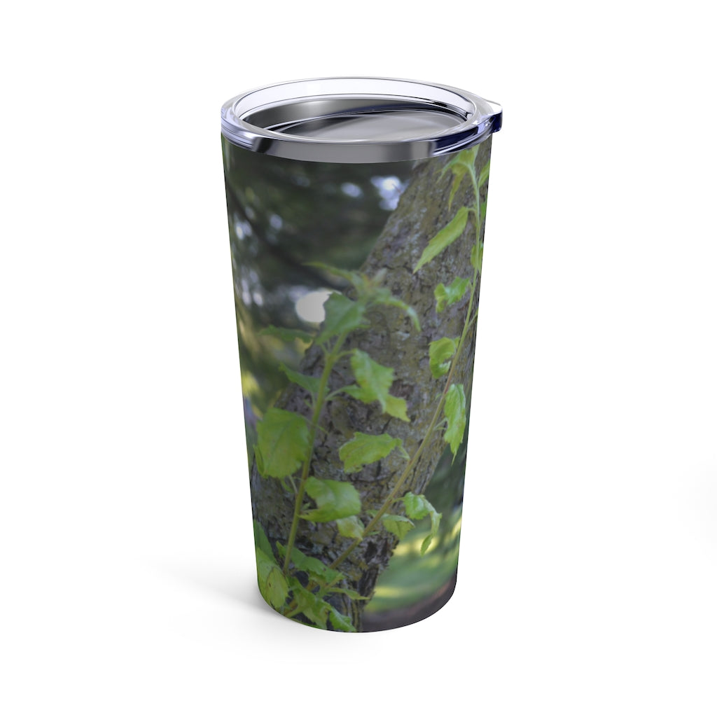 20oz stainless steel tumbler featuring a tree stump and green leaves design, perfect for travel and outdoor use.