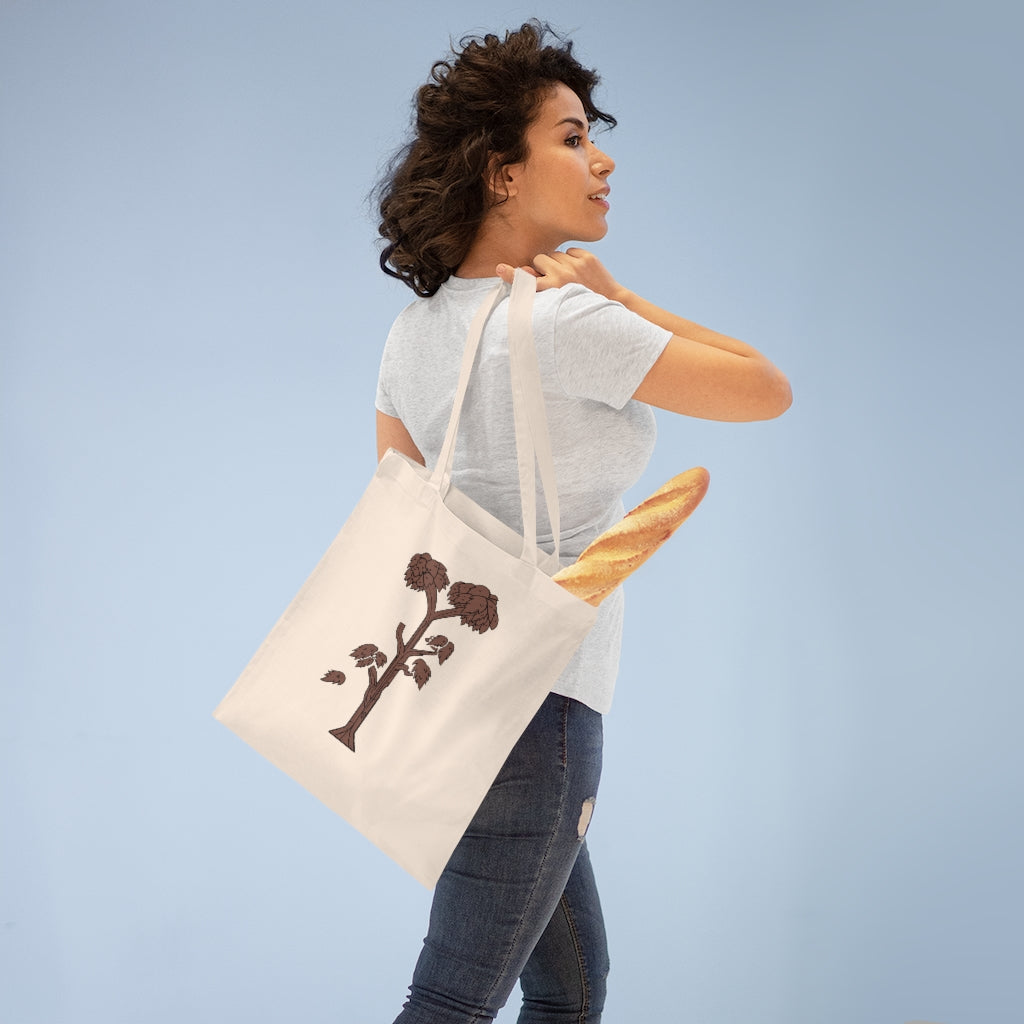 A stylish Tree Tote Bag made of 100% cotton, featuring long handles and cross stitching for durability, available in multiple colors.