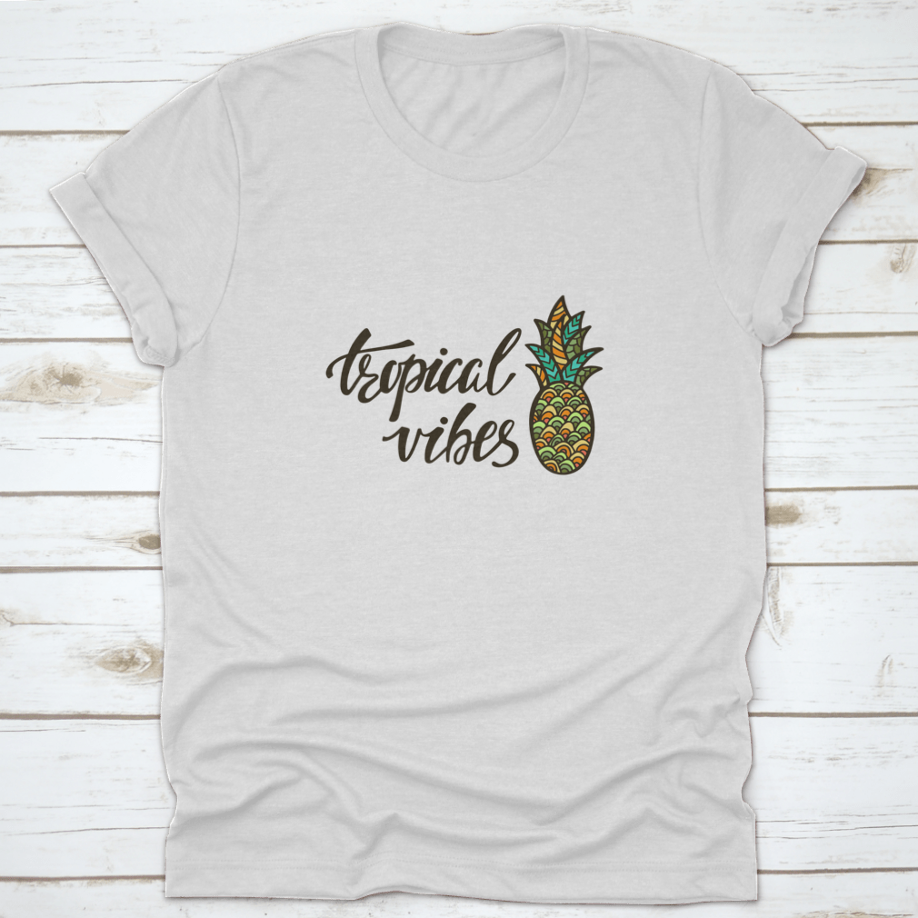 A stylish Tropical Vibes T-shirt featuring modern calligraphy with an inspirational summer quote, made from soft cotton fabric.