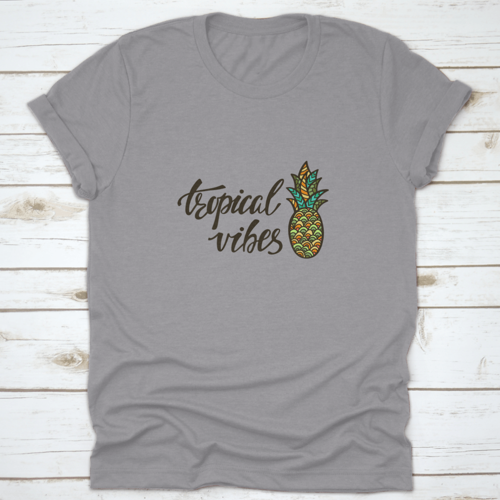 A stylish Tropical Vibes T-shirt featuring modern calligraphy with an inspirational summer quote, made from soft cotton fabric.