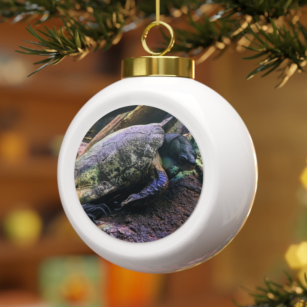 A beautifully crafted Turtle Christmas Ball Ornament featuring a glossy finish and gold ribbon, perfect for holiday decorating.