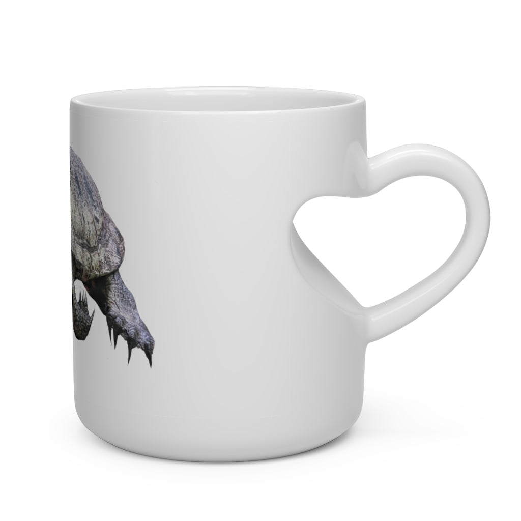 A white ceramic mug shaped like a heart with a heart-shaped handle, perfect for hot beverages.