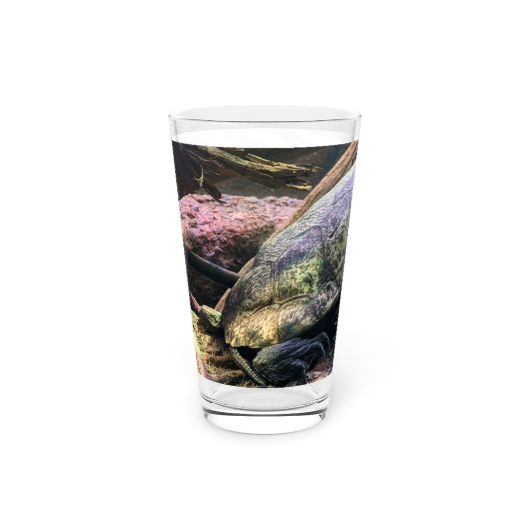 A clear 16oz Turtle Pint Glass showcasing a custom printed design, perfect for beverages.