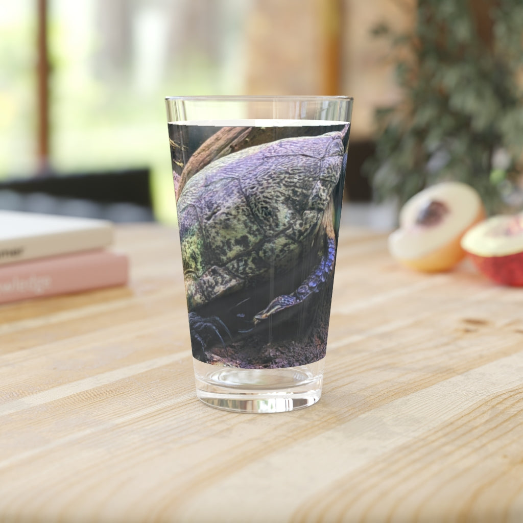 A clear 16oz Turtle Pint Glass showcasing a custom printed design, perfect for beverages.