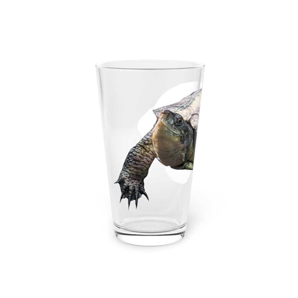 A clear 16oz Turtle Pint Glass showcasing a custom printed design, perfect for beverages and personalized gifts.