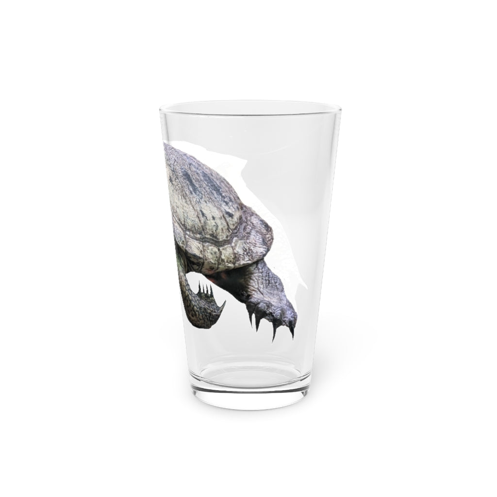 A clear 16oz Turtle Pint Glass showcasing a custom printed design, perfect for beverages and personalized gifts.