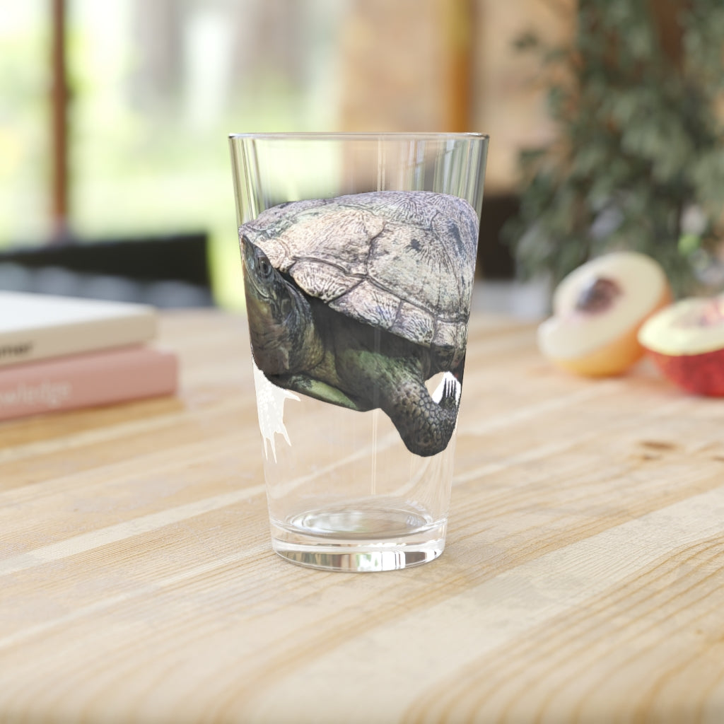 A clear 16oz Turtle Pint Glass showcasing a custom printed design, perfect for beverages and personalized gifts.